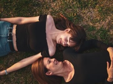 Maman et sa fille allongées dans l'herbe